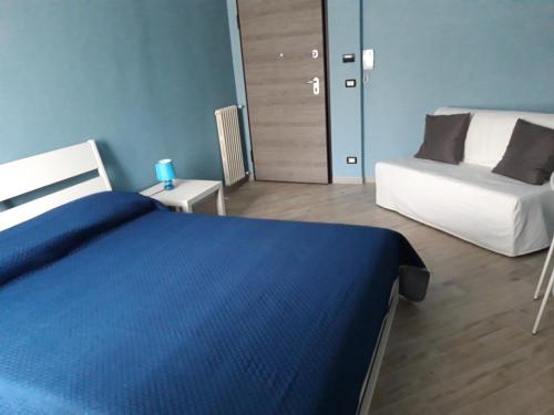 a bedroom with a blue bed and a white bed and a bed and a room at Locanda della luna rossa in Calosso
