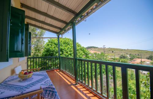 a balcony with a table and a view at Casa Tsounis in Volimes