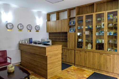 a kitchen with wooden cabinets and a table at Hotel Manastir Sv. Joakim Osogovski in Kriva Palanka