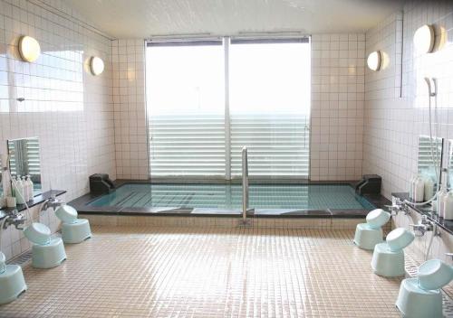 a bathroom with a shower and a tub with toilets at Kurashiki - Hotel / Vacation STAY 31267 in Kurashiki
