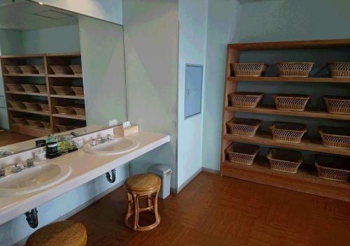 a bathroom with two sinks and a mirror and a stool at Kurashiki - Hotel / Vacation STAY 31267 in Kurashiki