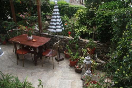 a patio with a table and chairs and plants at Family Hotel Emilia in Sozopol