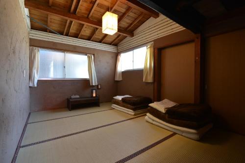 two beds in a room with two windows at Tsukubo-gun - House / Vacation STAY 34603 in Hayashima
