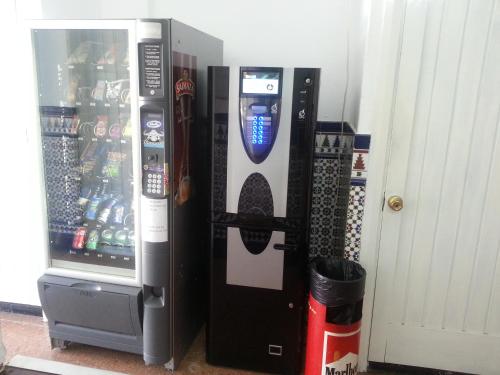 a vending machine with a cell phone on the side of it at Hostal Casa de Huéspedes San Fernando - Adults Only in Playa del Ingles