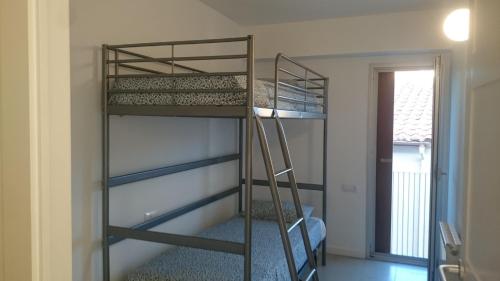 a bunk bed in a room with a ladder at Pis Firalet - Olot in Olot