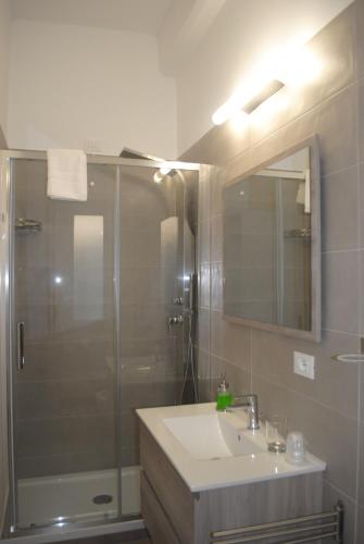 a bathroom with a shower and a sink and a mirror at B&B Vicomare in Crotone