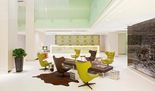 a dining room with green chairs and a table at Midas Hotel and Casino in Manila