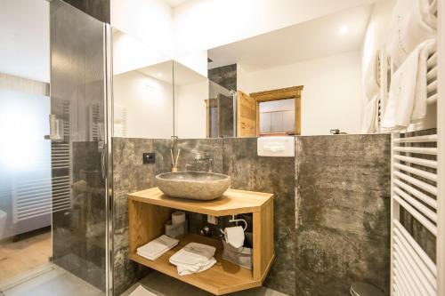 a bathroom with a sink and a shower at La Bercia Alpine Lodge & Spa in La Villa