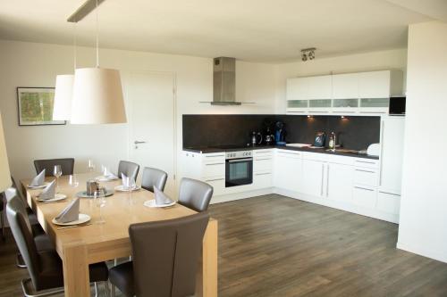 a kitchen and dining room with a wooden table and chairs at Resort Winterberg, Winterberg-Neuastenberg in Winterberg