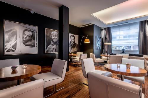 a restaurant with two tables and white chairs at Le Grand Balcon Hotel in Toulouse