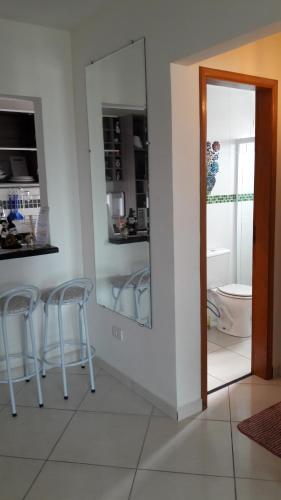 a kitchen with two stools and a mirror in a room at Mar Azul in Solemar