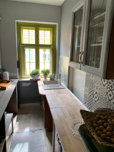 a kitchen with a wooden counter top and a window at Apartament w Kamienicy in Biskupiec