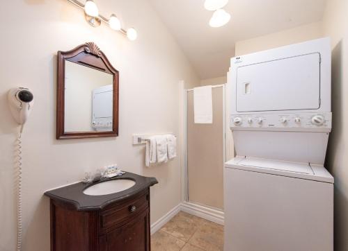 a bathroom with a sink and a refrigerator at Canadas Best Value Inn & Suites Summerside in Summerside