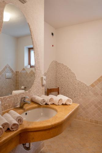 a bathroom with a sink and a mirror at Hotel Europa in Pozza di Fassa