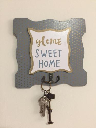 a key chain with a sign with a home sweet home at Zona Dorada Mazatlan in Mazatlán
