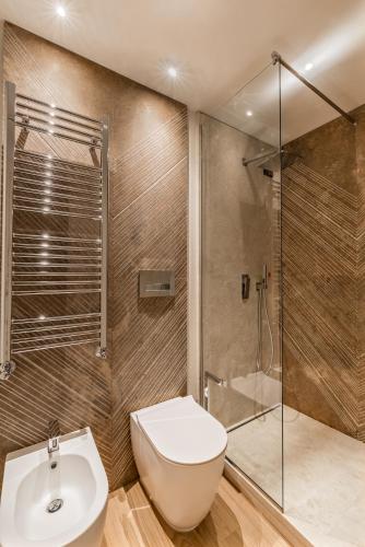 a bathroom with a shower and a toilet and a sink at Resort Miramonti in Forte dei Marmi