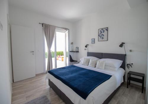 a bedroom with a large bed and a large window at Apartments Blue Horizon in Mlini