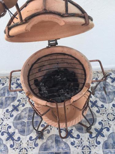 a wooden chair sitting on top of a table at City Apartment sur le port de Mahdia Free Wifi in Mahdia