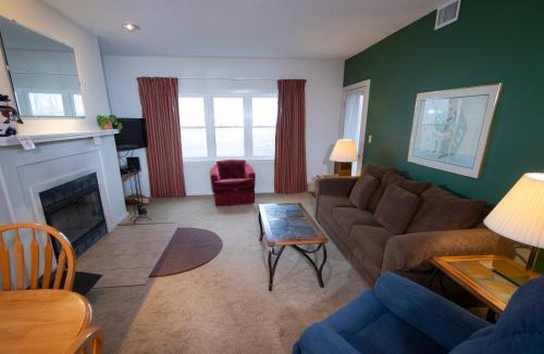 a living room with a couch and a fireplace at Winterplace on Okemo Mountain in Ludlow