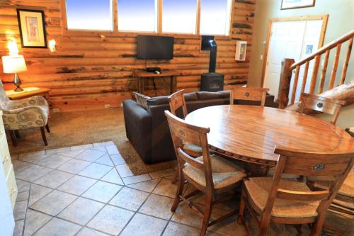 a living room with a wooden table and a couch at Zion Ponderosa Ranch Resort in Springdale