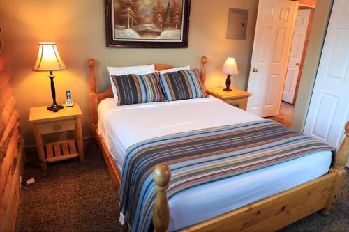 a bedroom with a bed with two lamps on tables at Zion Ponderosa Ranch Resort in Springdale