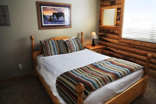 a bedroom with a bed in a log cabin at Zion Ponderosa Ranch Resort in Springdale