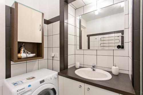 a bathroom with a washing machine and a sink at New Quiet Cozy City Center apartment in Vilnius