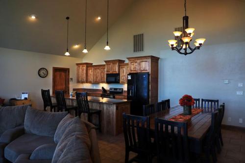 a kitchen and living room with a couch and a table at Zion Ponderosa Ranch Resort in Springdale