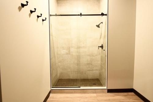 a shower with a glass door in a bathroom at Crosby Lofts in Crosby