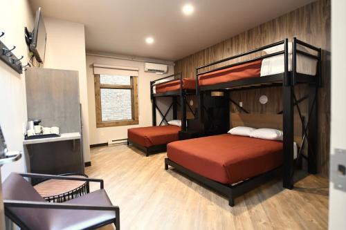 a bedroom with two bunk beds and a desk at Crosby Lofts in Crosby