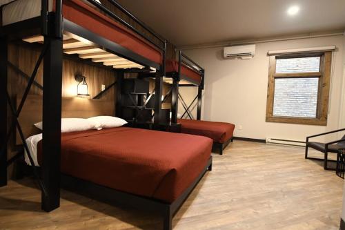 a bedroom with two bunk beds and a window at Crosby Lofts in Crosby