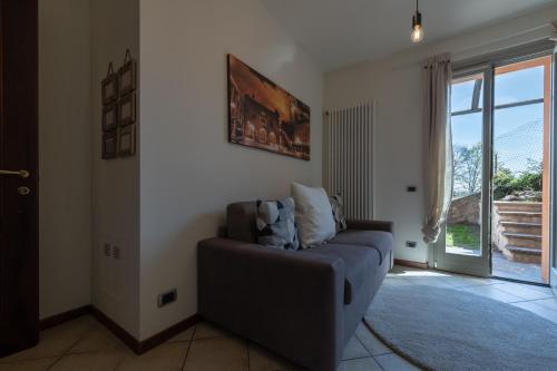 a living room with a couch and a window at Villa dei Venti - Comfort Holiday in Bergamo