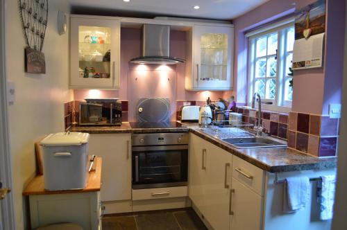 a kitchen with a sink and a stove at 19 Upper Linney in Ludlow