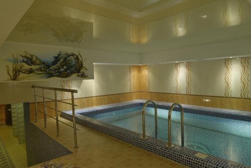 a large swimming pool in a building at Hotel Zumrat in Karagandy