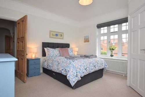 a bedroom with a bed and a window at B&B@no2 in Sheringham