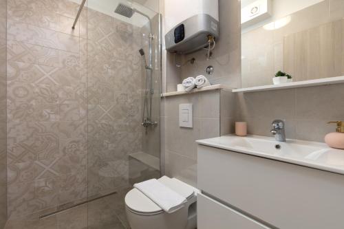 a bathroom with a shower and a toilet and a sink at Villa Anja in Split