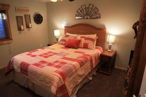a bedroom with a large bed with a red pillow at Zion Ponderosa Ranch Resort in Springdale