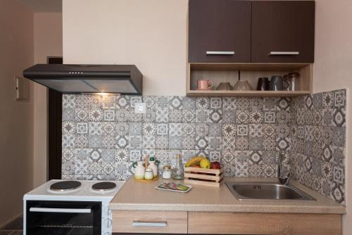 a small kitchen with a sink and a stove at Villa Georgia in Kalyves