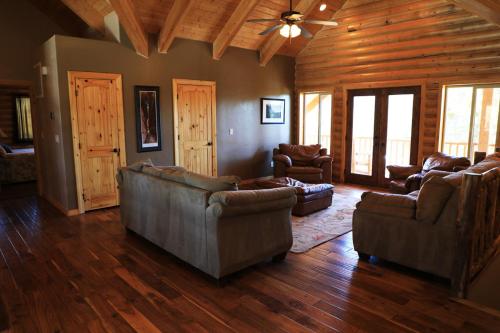 a living room with couches and chairs in a cabin at Zion Ponderosa Ranch Resort in Springdale