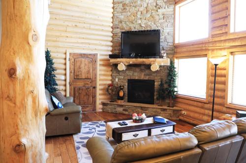 a living room with a couch and a fireplace at Zion Ponderosa Ranch Resort in Springdale
