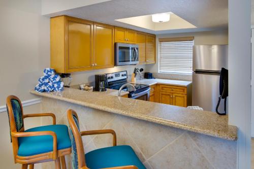 a kitchen with wooden cabinets and a counter top at FantasyWorld Resort in Kissimmee