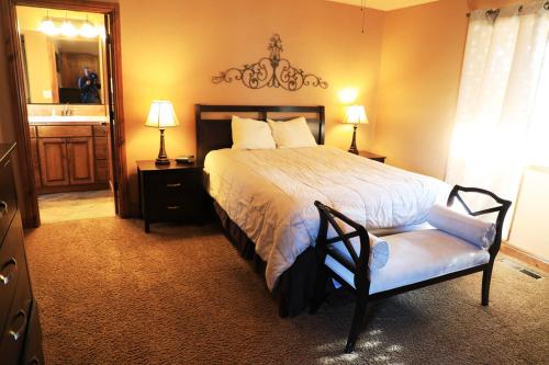 a bedroom with a bed and a chair and a mirror at Zion Ponderosa Ranch Resort in Springdale