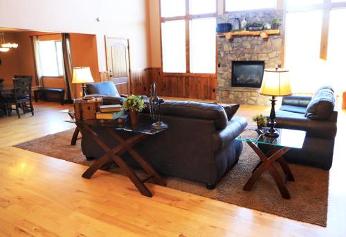 a living room with a couch and a fireplace at Zion Ponderosa Ranch Resort in Springdale