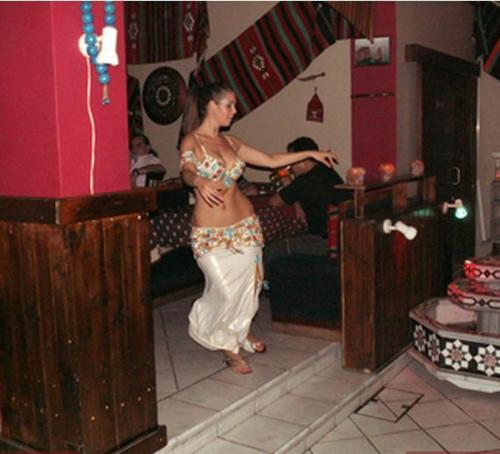 a woman in a dress dancing in a room at Sky Hotel in Nicosia