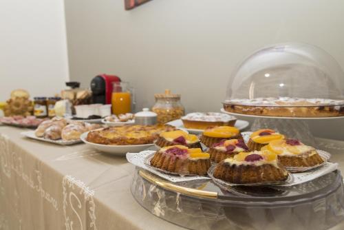 a table with many different types of cakes and pastries at La Dimora Di Segesta B&B in Calatafimi