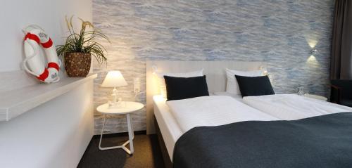 a bedroom with two beds and a wall with a mural at Trend Hotel in Oldenburg