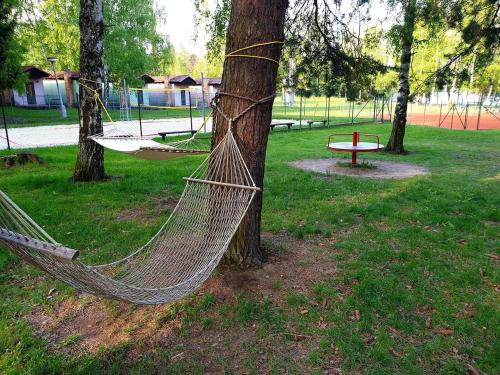 a hammock tied to a tree in a park at Chatový tábor Malý Ratmírov in Malý Ratmírov