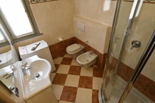 a bathroom with a toilet and a sink and a shower at Villa dei Venti - Comfort Holiday in Bergamo