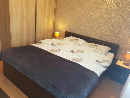 a bed with white sheets and pillows in a bedroom at Apartament Puck in Puck