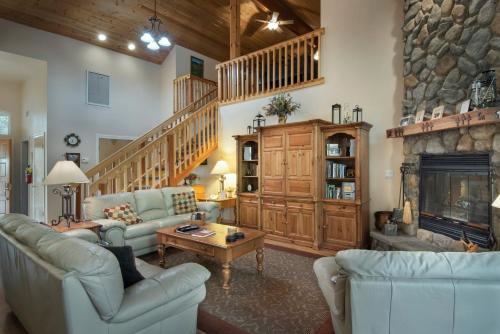 a living room with two couches and a fireplace at 2A The Terry Cabin in North Wawona
